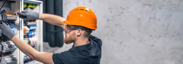 electrician-working-switchboard-with-electrical-connection-cable-copy-space_169016-53646