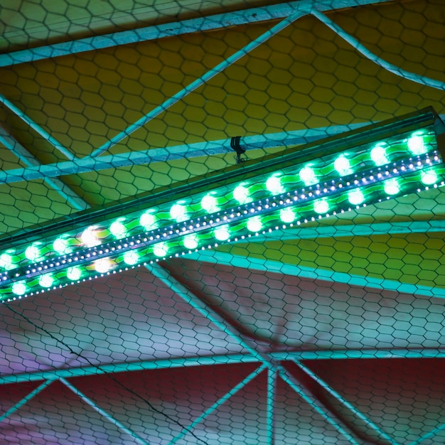 funfair-top-night-with-green-blue-lights_23-2148281654