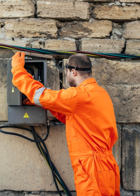 side-view-electrician-with-uniform-face-shield_23-2148773439